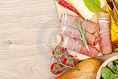 Cheese, prosciutto, bread, vegetables and spices Stock Photo