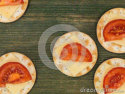 Cheese and Tomato on Water Biscuit Crackers Stock Photo