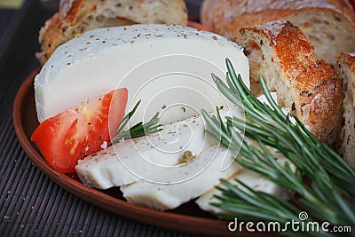 Cheese, tomatoes, herbs and bread Stock Photo