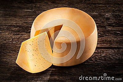 Cheese wheel on wood. Organic food Stock Photo