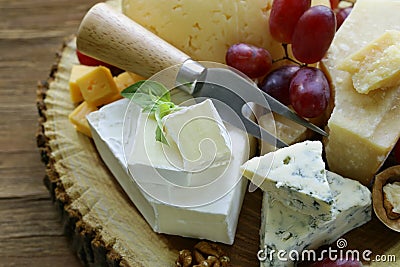 Cheeseboard with assorted cheeses Stock Photo