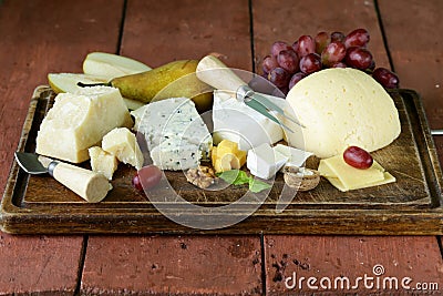 Cheeseboard with assorted cheeses Stock Photo