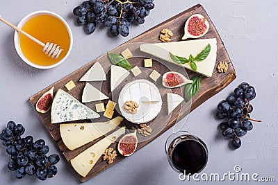 Cheeseboard with cheese brie parmesan , camembert and dorblu . Food on wooden board Stock Photo