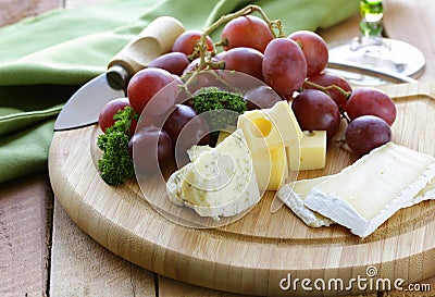 Cheeseboard with cheese and grapes Stock Photo