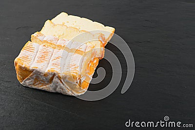 Cheeseboard with Sliced Yellow Cheese Close Up Stock Photo