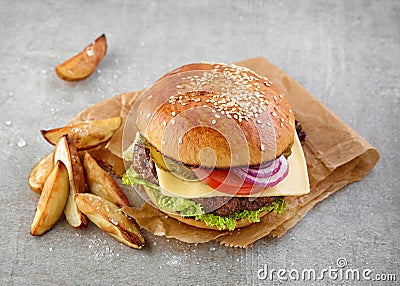 Cheeseburger and potato wedges Stock Photo