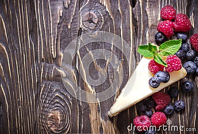 Cheesecake with berries on blue slate background. Stock Photo