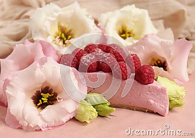 Cheesecake with raspberries and fresh flowers on a plate Stock Photo