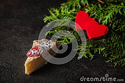 Cheesecake on Valentine`s Day with strawberry, kiwi hearts on fir and dark background Stock Photo