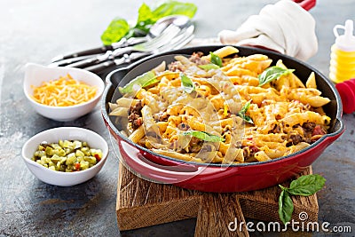 Cheesy pasta bake with ground beef and herbs Stock Photo