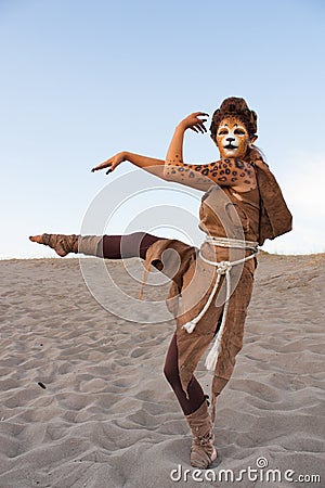 Cheetah woman dances in desert Stock Photo