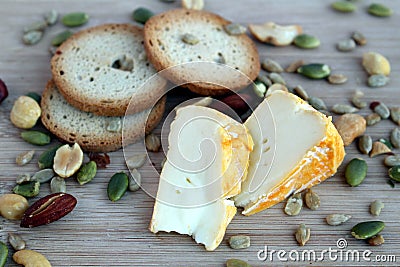 Cheeze snack with crackers and mixed nuts on a wooden board Stock Photo