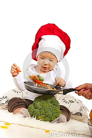 Chef baby taking macaroni Stock Photo