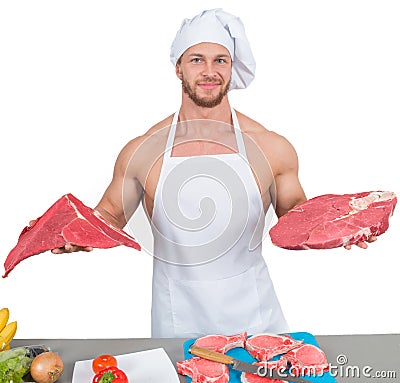 Chef bodybuilder preparing large chunks of raw Stock Photo