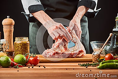 Chef brushing raw beef ribs with marinade Stock Photo