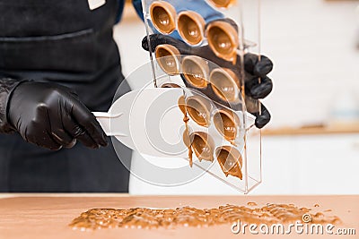 Chef or chocolatier making sweet chocolates home on background of kitchen Stock Photo