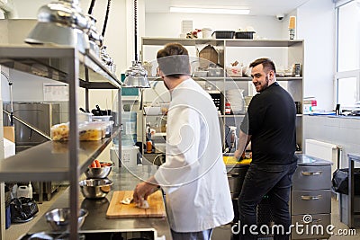 Chef and cook cooking food at restaurant kitchen Stock Photo