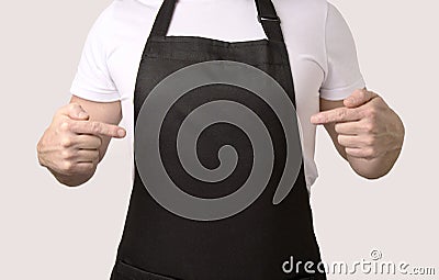 Chef cook pointing on black apron Stock Photo