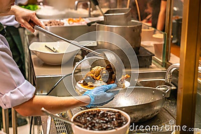 Chef cooking clams, mussel, cockle in kitchen Stock Photo