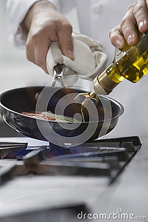 Chef Cooking Food In Frying Pan Stock Photo