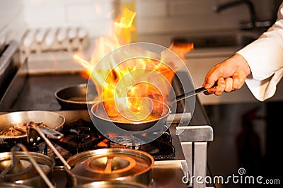 Chef cooking in kitchen stove Stock Photo