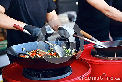 Chef Cooking Thai Dish Closeup At Street Food Festival. Stock Photo