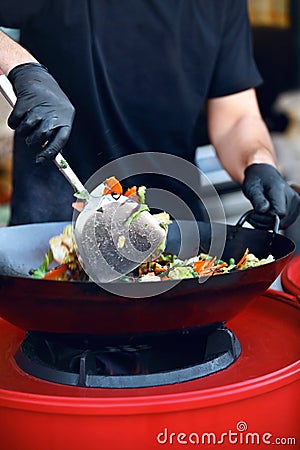 Chef Cooking Thai Dish Closeup At Street Food Festival. Stock Photo