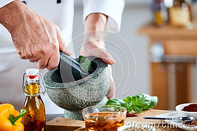 Chef crushing a blending fresh herbs Stock Photo