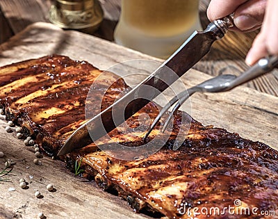 Chef cut up barbecue ribs. Stock Photo