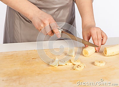 Chef cuts a banana Stock Photo