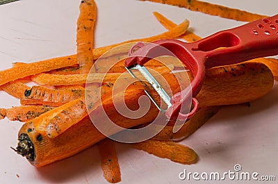 The chef cuts a carrot with a knife Stock Photo