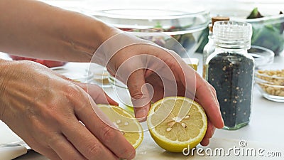 Chef cuts lemon in half. Salad dressing recipe Stock Photo