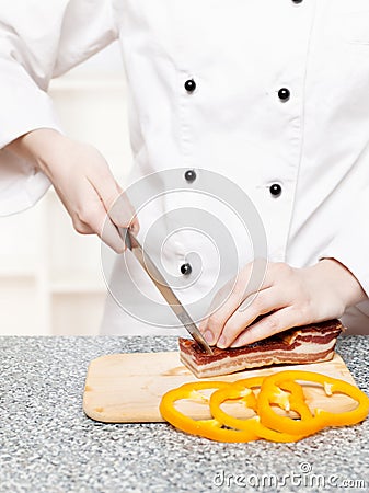 Chef cutting bacon Stock Photo