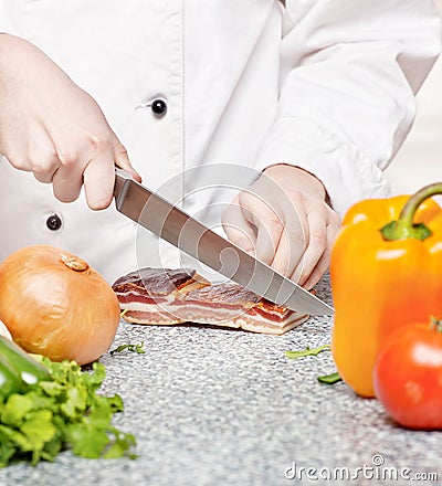 Chef cutting bacon Stock Photo