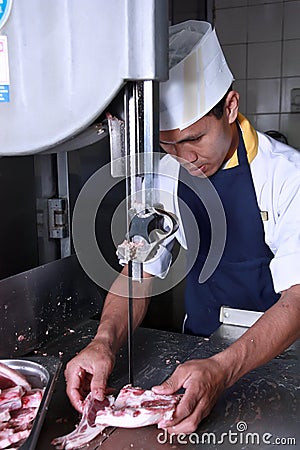 Chef cutting meat Stock Photo