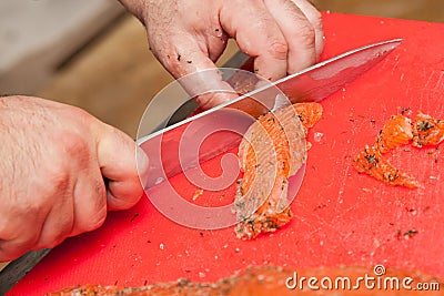 Chef Cutting salmon fish Stock Photo