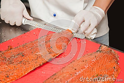 Chef Cutting salmon fish Stock Photo