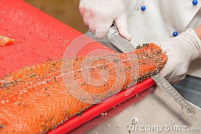 Chef Cutting salmon fish Stock Photo