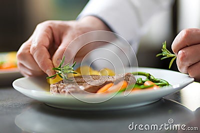 Chef garnishing a dish Stock Photo