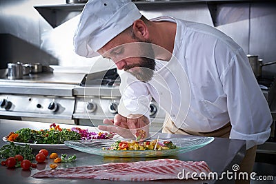 Chef garnishing flower in ceviche dish Stock Photo