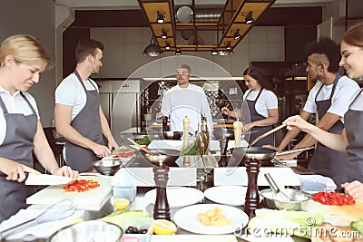 Chef and group of young people during cooking classes Stock Photo