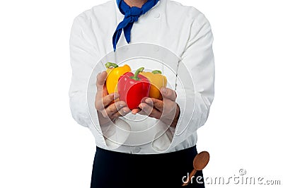 Chef hands showing fresh capsicums Stock Photo