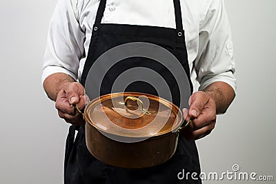 Chef holding copper pan Stock Photo