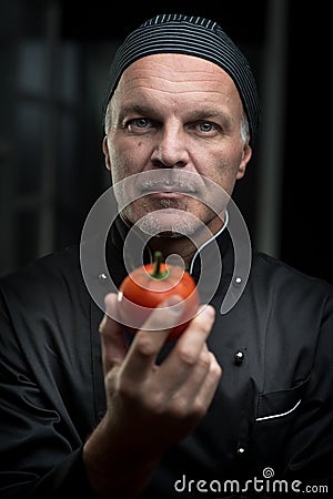 Chef holding a tomato Stock Photo