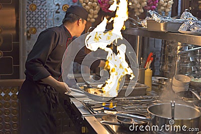 A chef in a hotel is showing his brilliant technique in cooking to visitors in Ha Noi city Editorial Stock Photo