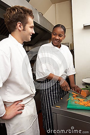 Chef Instructing Trainee Stock Photo