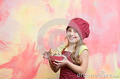 Chef kid in cook hat, apron hold cookies or biscuits Stock Photo