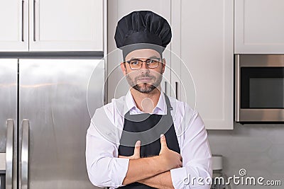 Chef on kitchen. Professional chef man in uniform on kitchen. Bearded chef, cook or baker. Male chef over kitchen Stock Photo