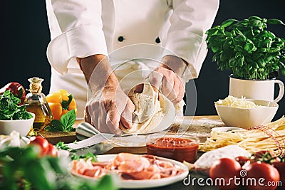 Chef kneading pastry dough for pasta or pizza Stock Photo