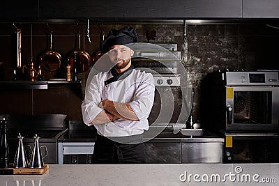 Chef young bearded man at kitchen restaurant Stock Photo